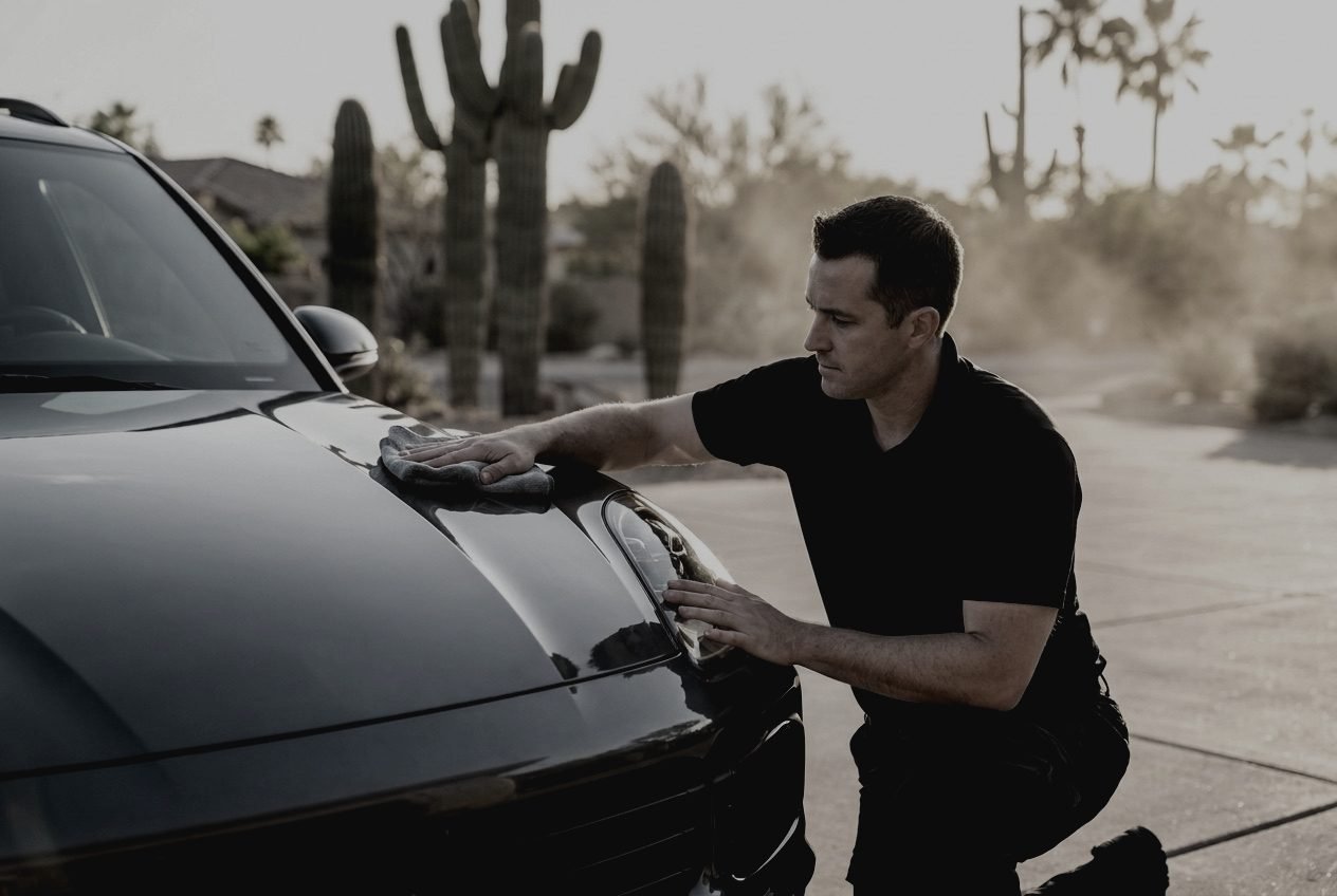 SUV hood before detailing, dull paint in a Scottsdale driveway